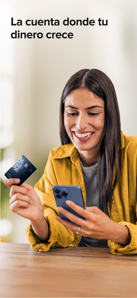 A smiling woman holding a Mercado Pago card and a smartphone