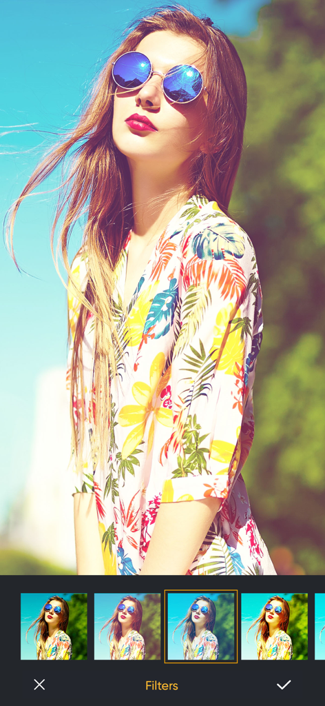 Una interfaz de edición de fotos que muestra diferentes opciones de filtros aplicadas a un retrato de una mujer con gafas de sol