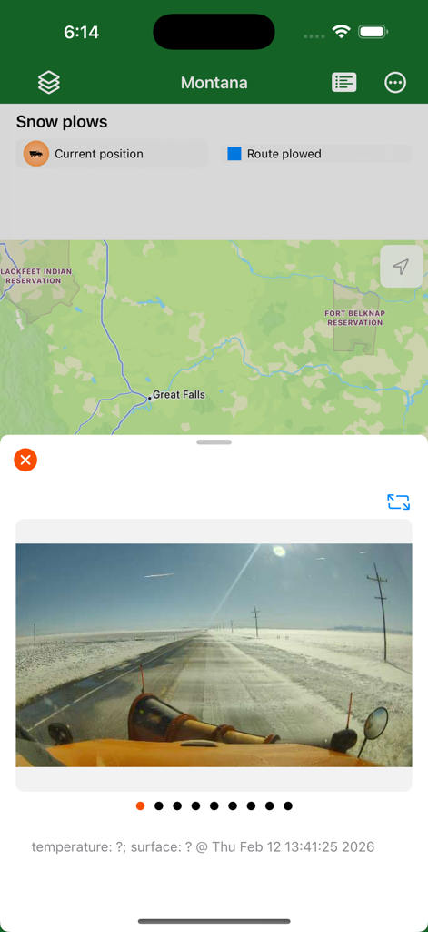 Montana Traveler app screenshot showing a map with snow plow tracking and a real-time dashboard camera view from a plow on a snowy road.