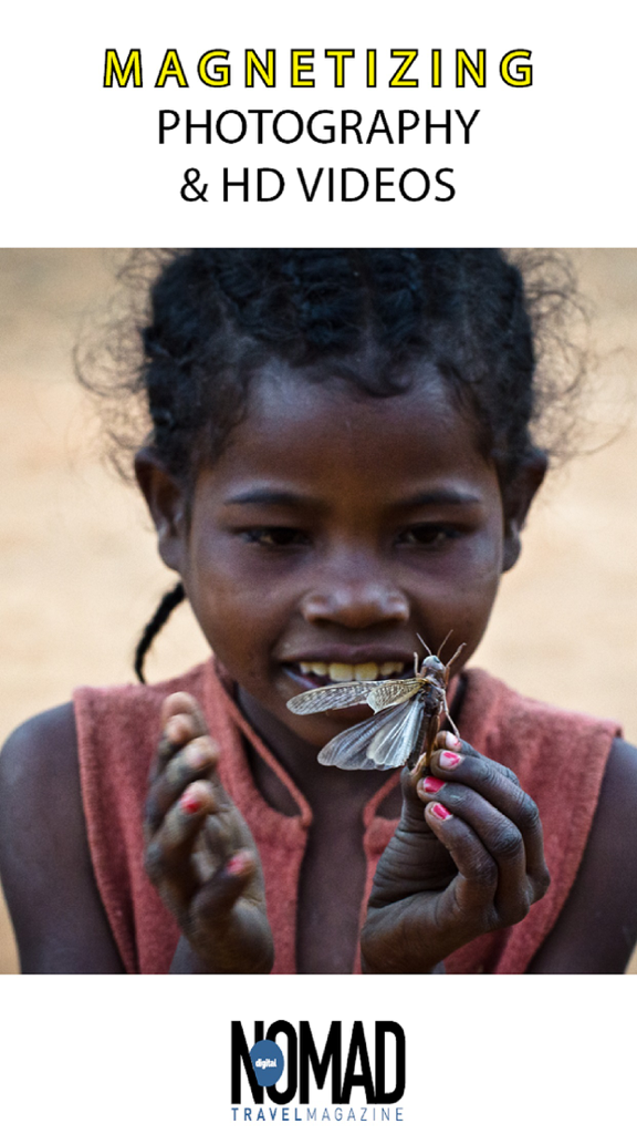A close-up photograph of a young girl holding a large insect from the Digital Nomad Travel Magazine