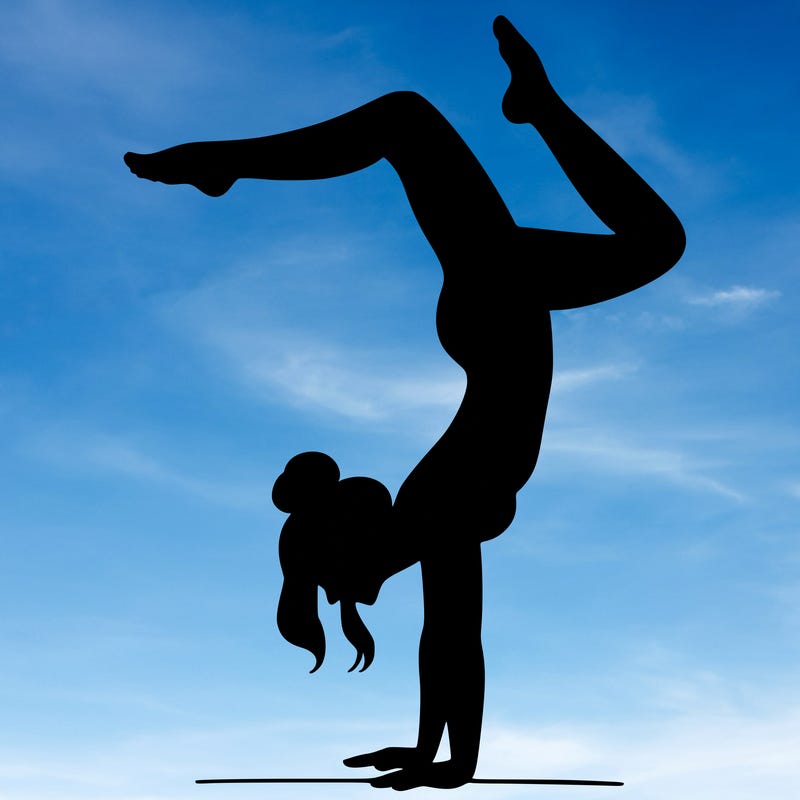 a woman doing a handstand