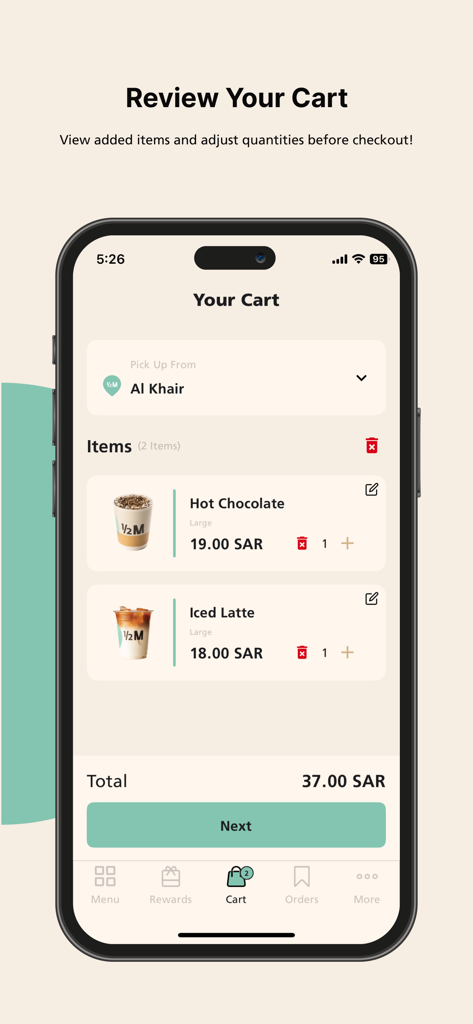 The checkout screen of the Half Million coffee app displaying a cart with hot chocolate and iced latte.