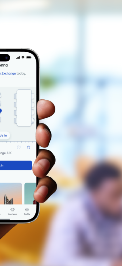 Hand holding a mobile phone displaying the Eptura Engage app workspace floor plan