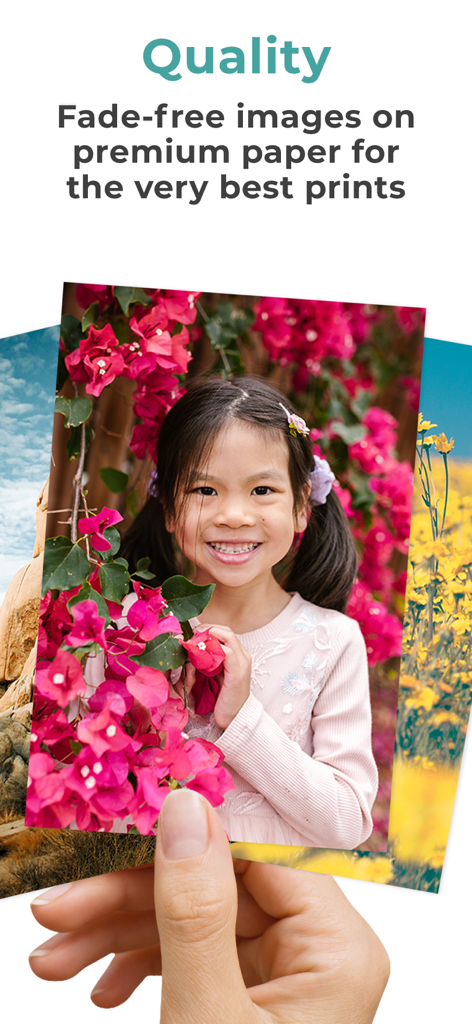 Hand holding a high quality photo print of a smiling young girl