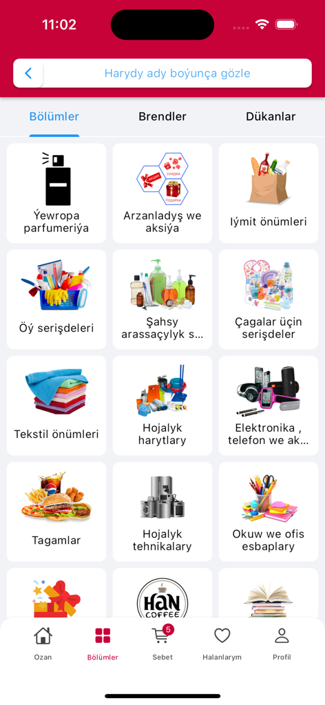 Ozan - Interfaz de la aplicación móvil que muestra una cuadrícula de categorías de productos que incluyen alimentos, electrónica y perfumes en idioma turcomano.