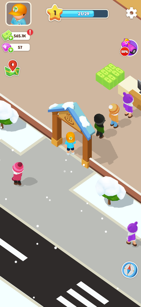 Una vista dall'alto dell'ingresso di un hotel innevato con ospiti in fila in Il Mio Hotel da Sogno.