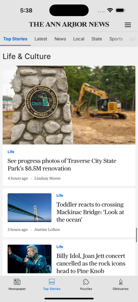 The Ann Arbor News mobile app interface displaying local life and culture news articles