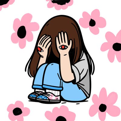 girl sitting down covering her head