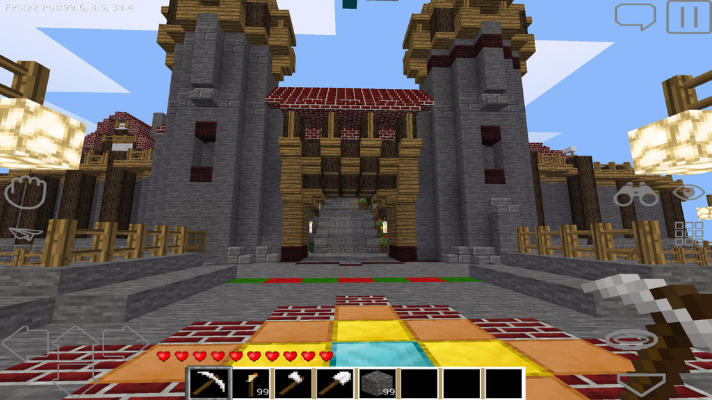FreeCraft Survival Pocket Edition - First person view of a large stone castle and fortress in a block based survival game.