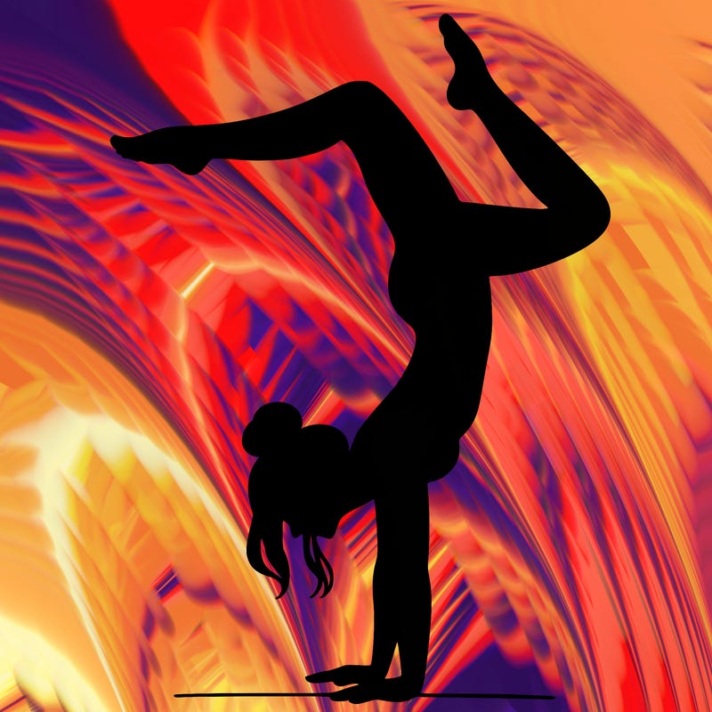 a woman doing a handstand