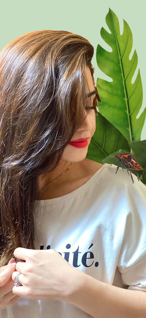 Insecta - Bug Identifier - A woman using the Insecta app to display a realistic 3D augmented reality bug on her shoulder