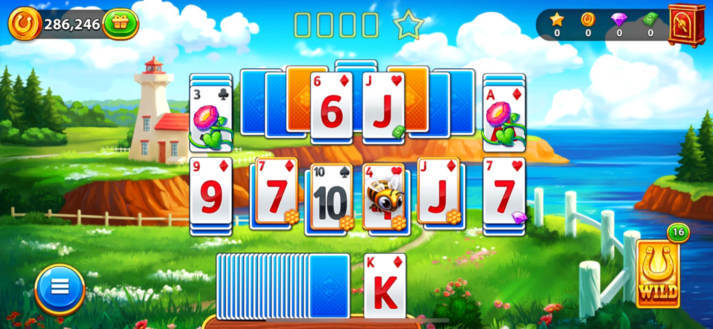 Solitaire Tripeaks card game layout with a scenic lighthouse and prairie background.