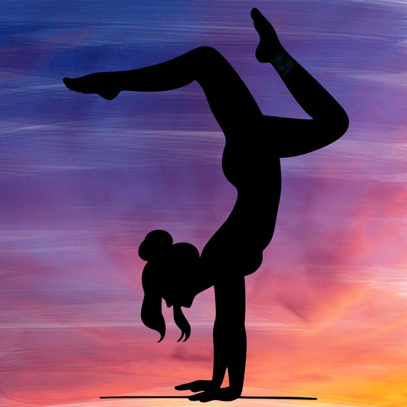 a woman doing a handstand