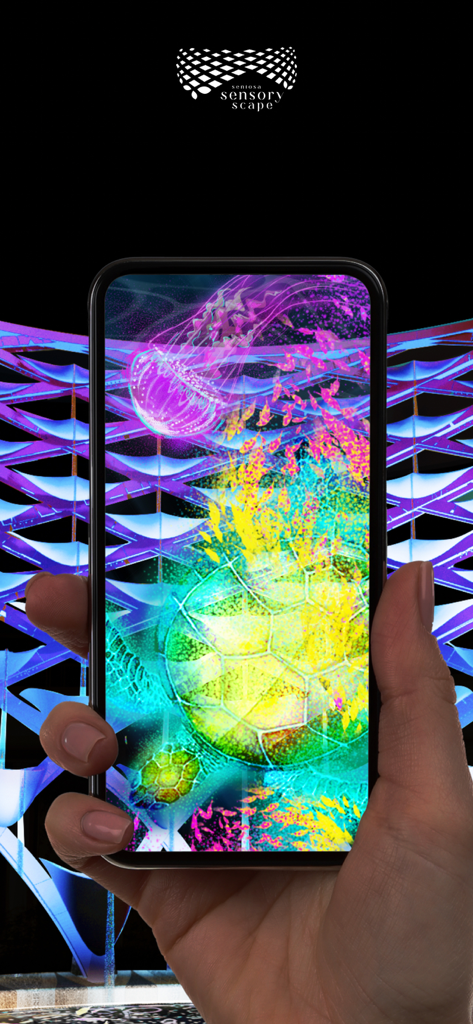 iPhone screen displaying vibrant augmented reality projections of a sea turtle and jellyfish at Sentosa Sensoryscape.