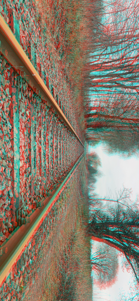 3D Camera One Shot - A stereoscopic 3D anaglyph image of a railroad track with red and cyan color shifts