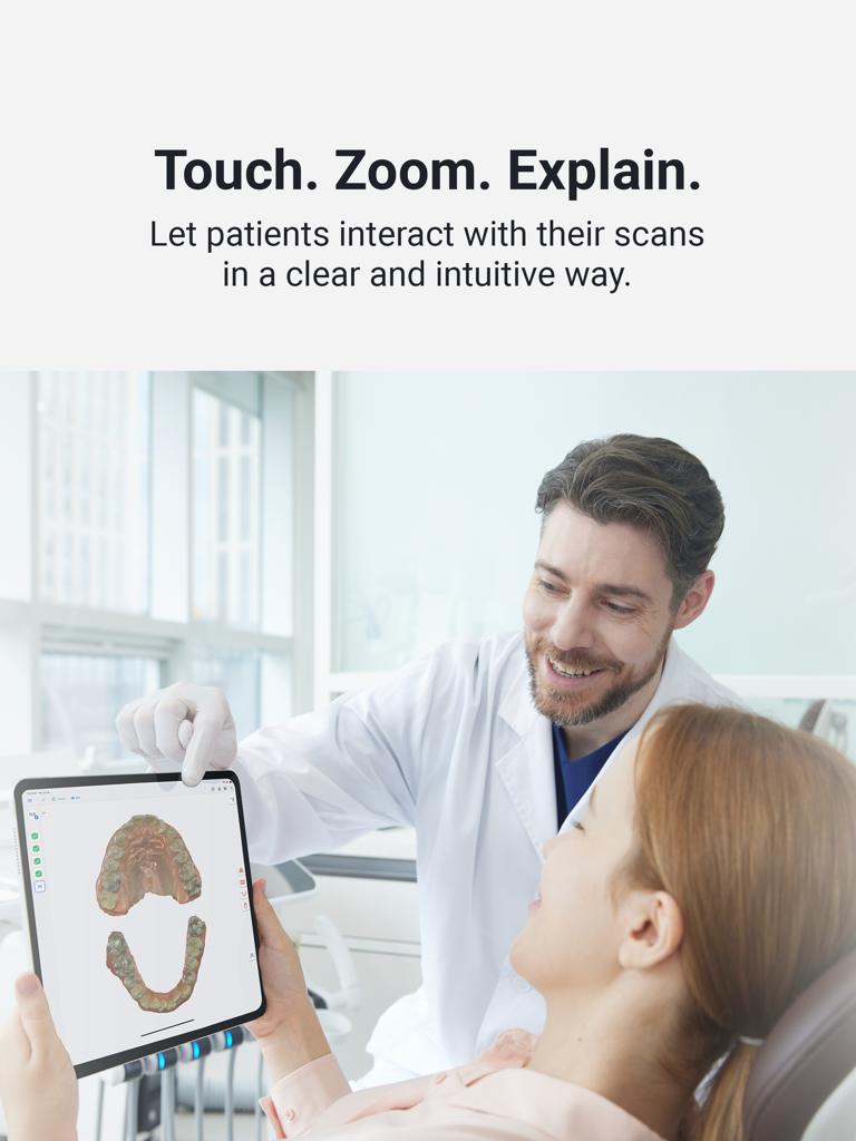 A dentist showing a 3D dental scan on an iPad to a patient during a consultation