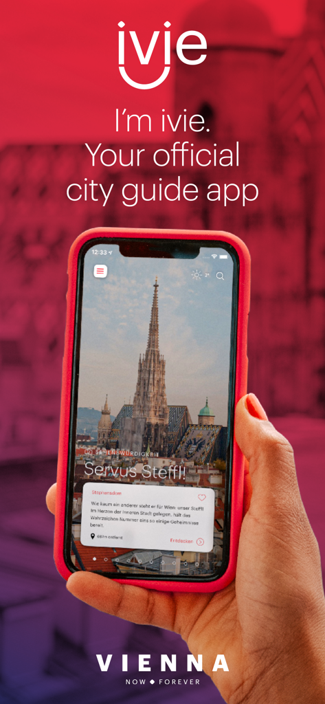 ivie – Official Vienna Guide - A hand holding a smartphone displaying the ivie official Vienna guide app with a picture of St Stephens Cathedral