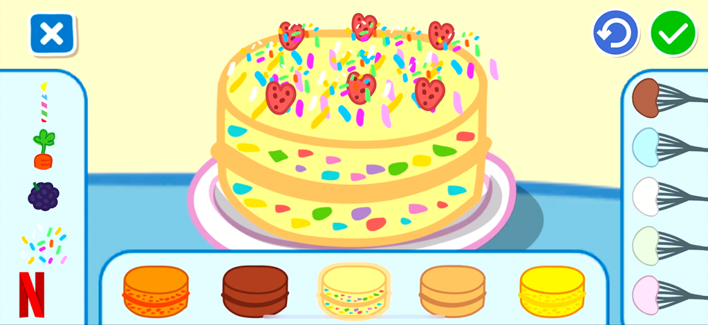 Una actividad de decoración de pasteles digitales en la aplicación Peppa Pig Netflix con un pastel amarillo con chispas y adornos en forma de corazón.