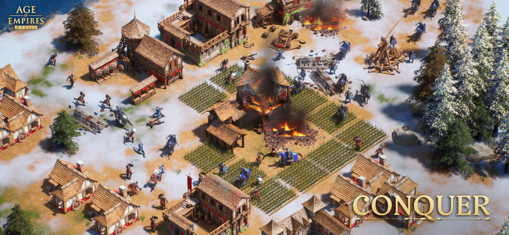 Age of Empires Mobile - Jugabilidad de Age of Empires Mobile mostrando un pueblo medieval bajo ataque durante el invierno con un trabuco y edificios en llamas