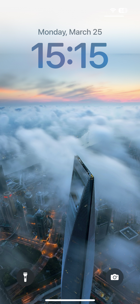 High-definition iPhone lock screen wallpaper featuring a skyscraper rising above a sea of clouds