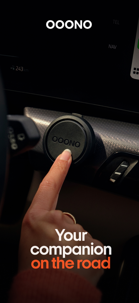 A person pressing the OOONO CO-DRIVER device mounted on a car dashboard
