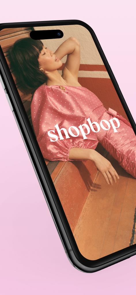 Woman wearing a pink polka dot dress on the Shopbop app screen
