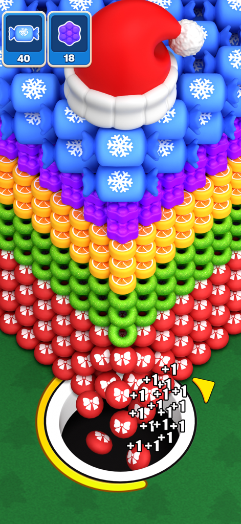 A black hole swallowing colorful objects and red candies in a festive Christmas-themed puzzle level with a Santa hat.