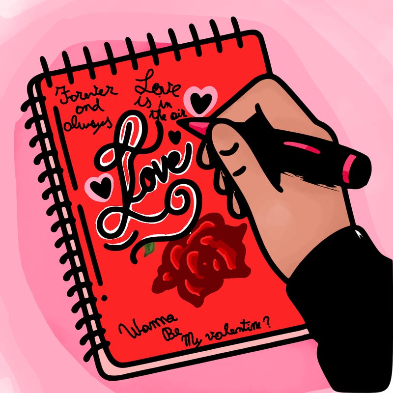 a hand writing “love” in calligraphy on a notebook