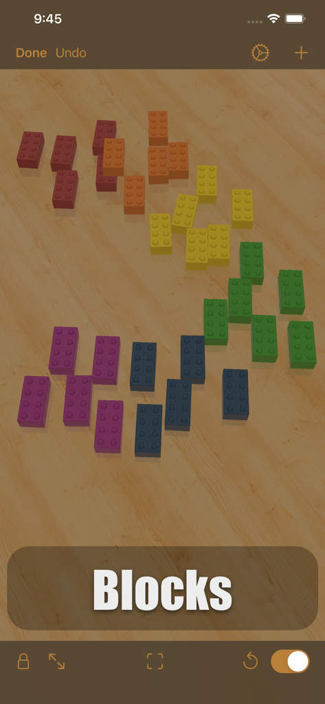 iCircuit 3D - Blocos de construção 3D coloridos espalhados em uma bancada de madeira virtual na interface do aplicativo iCircuit 3D.