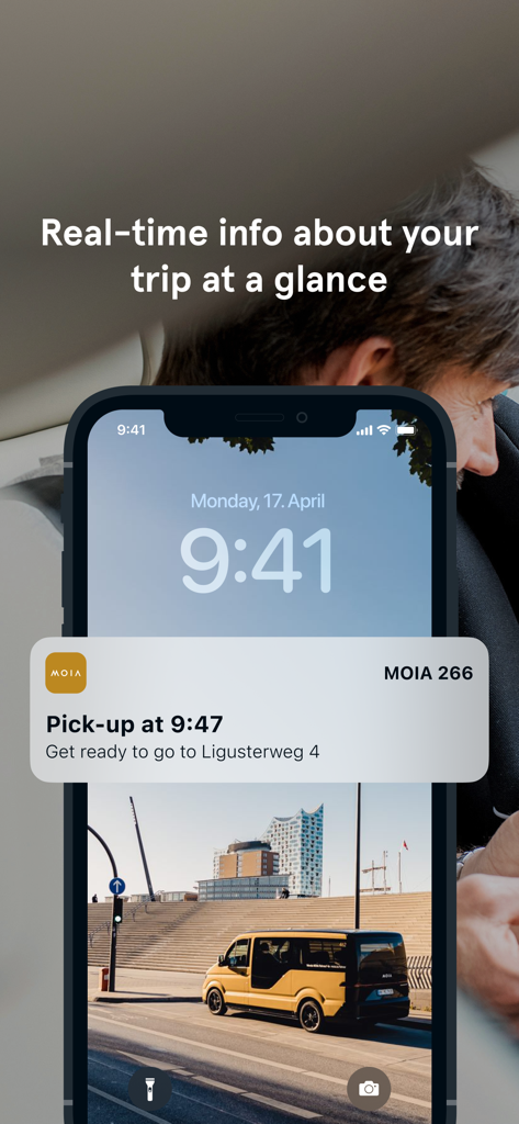 MOIA app real-time notification on an iPhone lock screen showing a scheduled pick-up time for a ride.