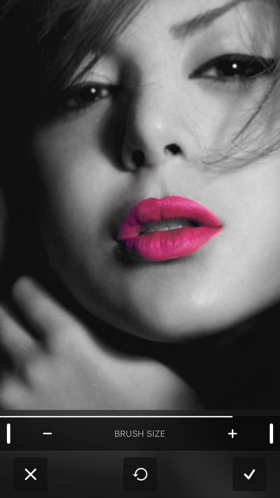 Color Accent - Black and white photo of a woman with bright pink selective color on her lips using the Color Accent app editing interface