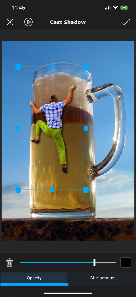 A surreal photo composite of a person climbing a giant mug of beer being edited with the Superimpose cast shadow tool.