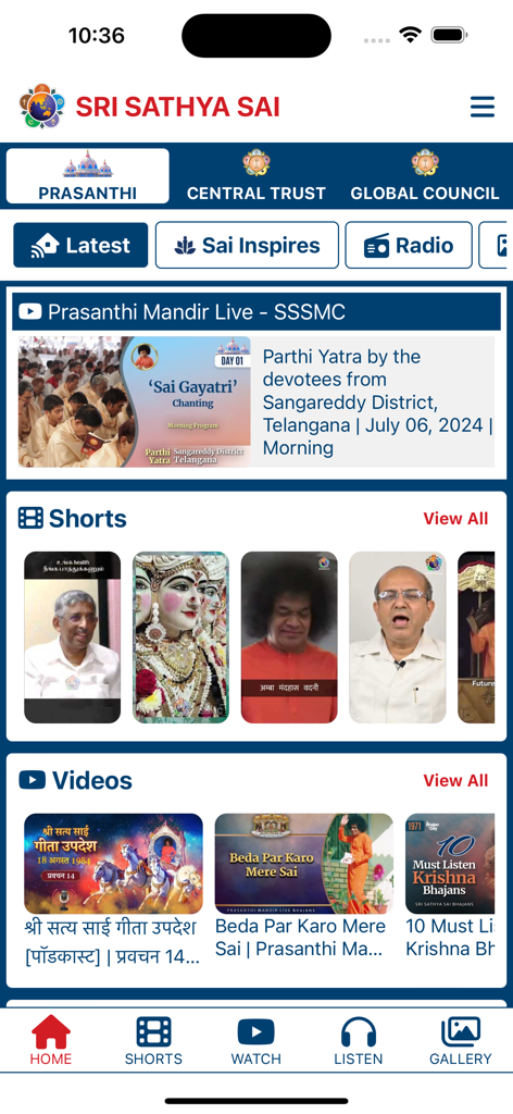 Prasanthi Connect - The home screen of the Prasanthi Connect app featuring devotional videos, shorts, and spiritual content buttons like Sai Inspires and Radio.