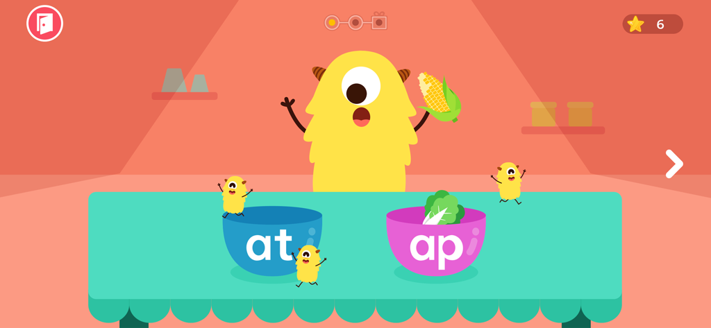 Eine gelbe Monsterfigur in einem Lautierspiel sortiert CVC-Wortendungen in Schüsseln.