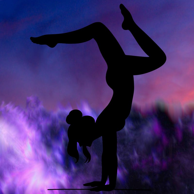 a woman doing a handstand