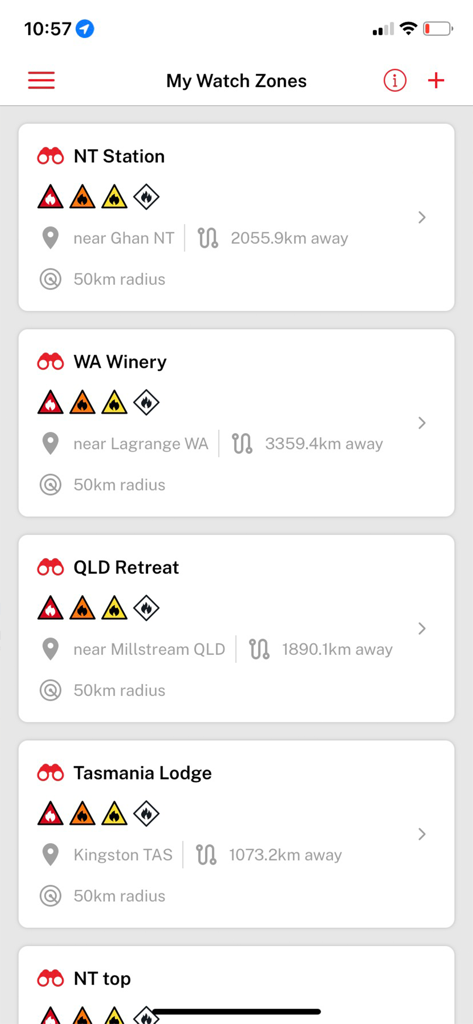 Fires Near Me Australia - Screenshot of the My Watch Zones screen in the Fires Near Me Australia app listing several monitored locations with fire warning icons.