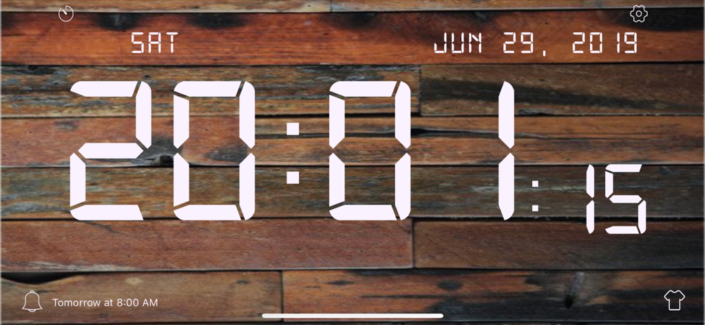 Digital clock display with white LED numbers on a rustic wooden background
