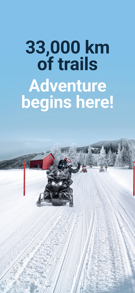 Snowmobilers riding on a groomed trail in a snowy landscape with a red barn in the background