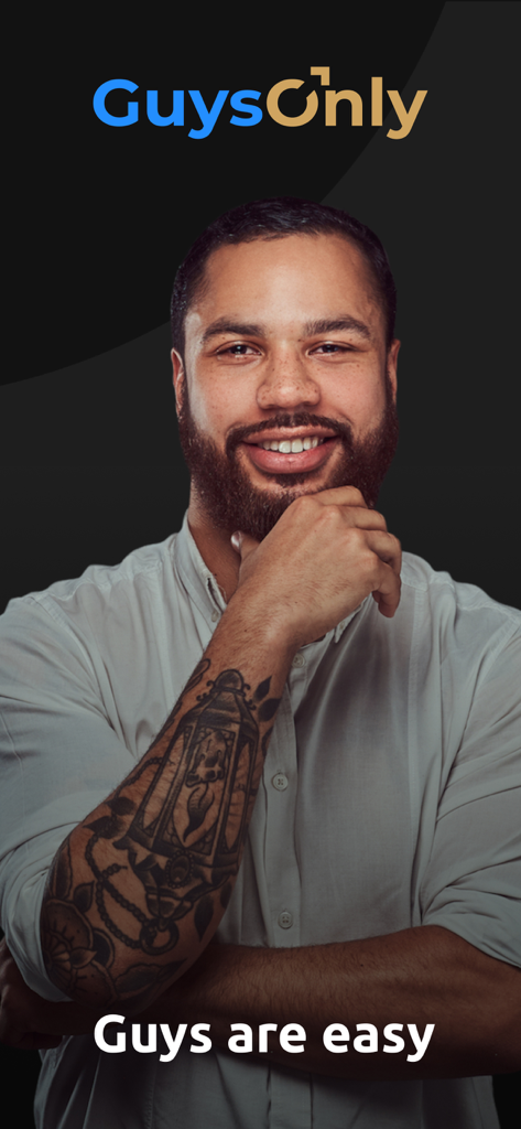Smiling man with arm tattoo on the GuysOnly gay dating app interface.