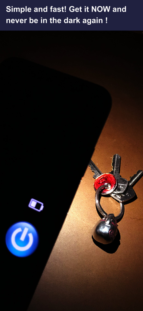 Smartphone flashlight app illuminating a set of keys and a skull keychain on a wooden surface