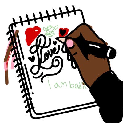 a hand writing “love” in calligraphy on a notebook