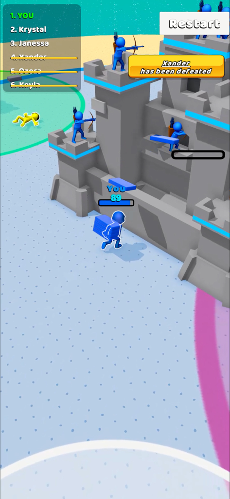 Outdo.io - A blue character carrying bricks to upgrade a grey castle defended by archers in Outdo.io gameplay.
