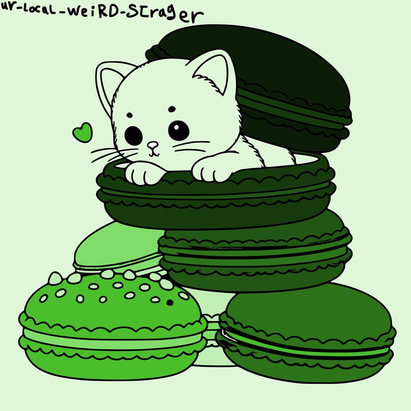 a kitten popping out of a stack of pastel macarons