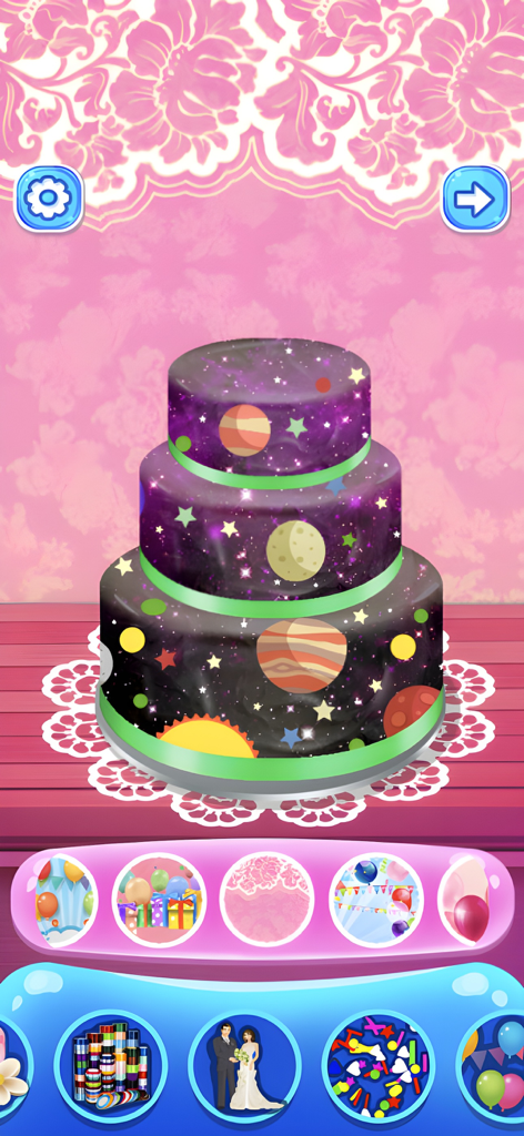 Cake Maker Game - A three tiered cake with a space and planet theme being decorated in a kids cooking game