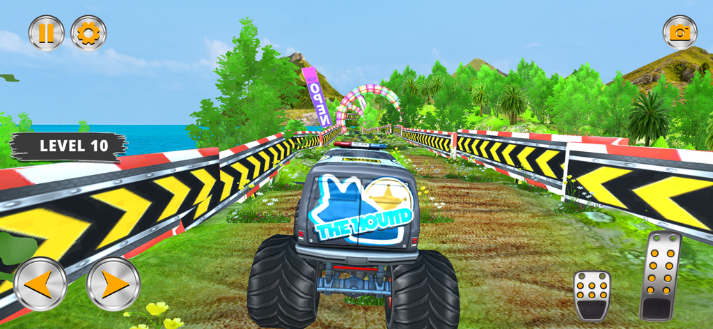 A monster truck driving through a narrow dirt path with yellow and black safety barriers in an off road simulator game.