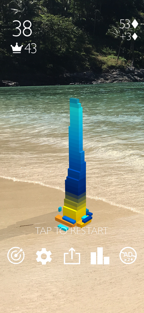 Stack AR - A colorful block tower stacked on a beach using augmented reality in the Stack AR app