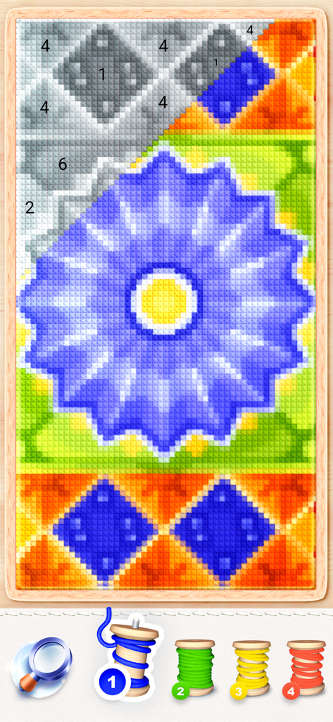 Digital cross stitch gameplay showing a blue flower pattern and color by number spools