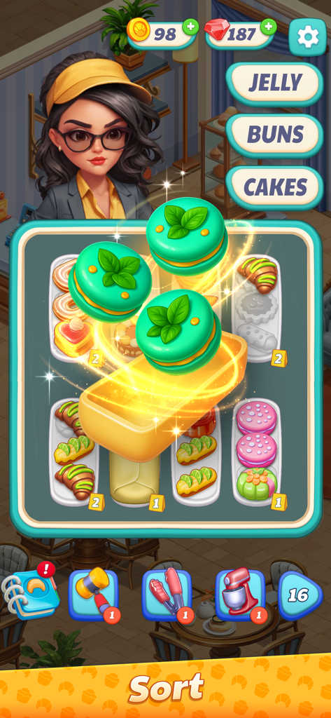 Sweet Dreams: Bakery Adventure - Pantalla de juego de Sweet Dreams Bakery Adventure con un rompecabezas de clasificación de pasteles con macarons de menta y el personaje Eva.