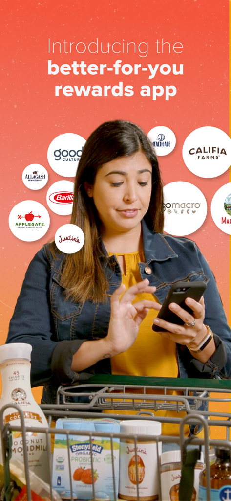 A woman using a smartphone to scan receipts for rewards while shopping for healthy grocery brands