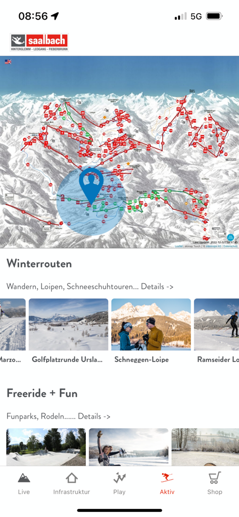 Saalbach Hinterglemm - Saalbach Hinterglemm app interface showing a mountain ski map with winter activity routes and navigation menu